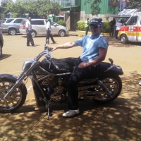 Chris Lloyd on a Harley Davidson in Kenya